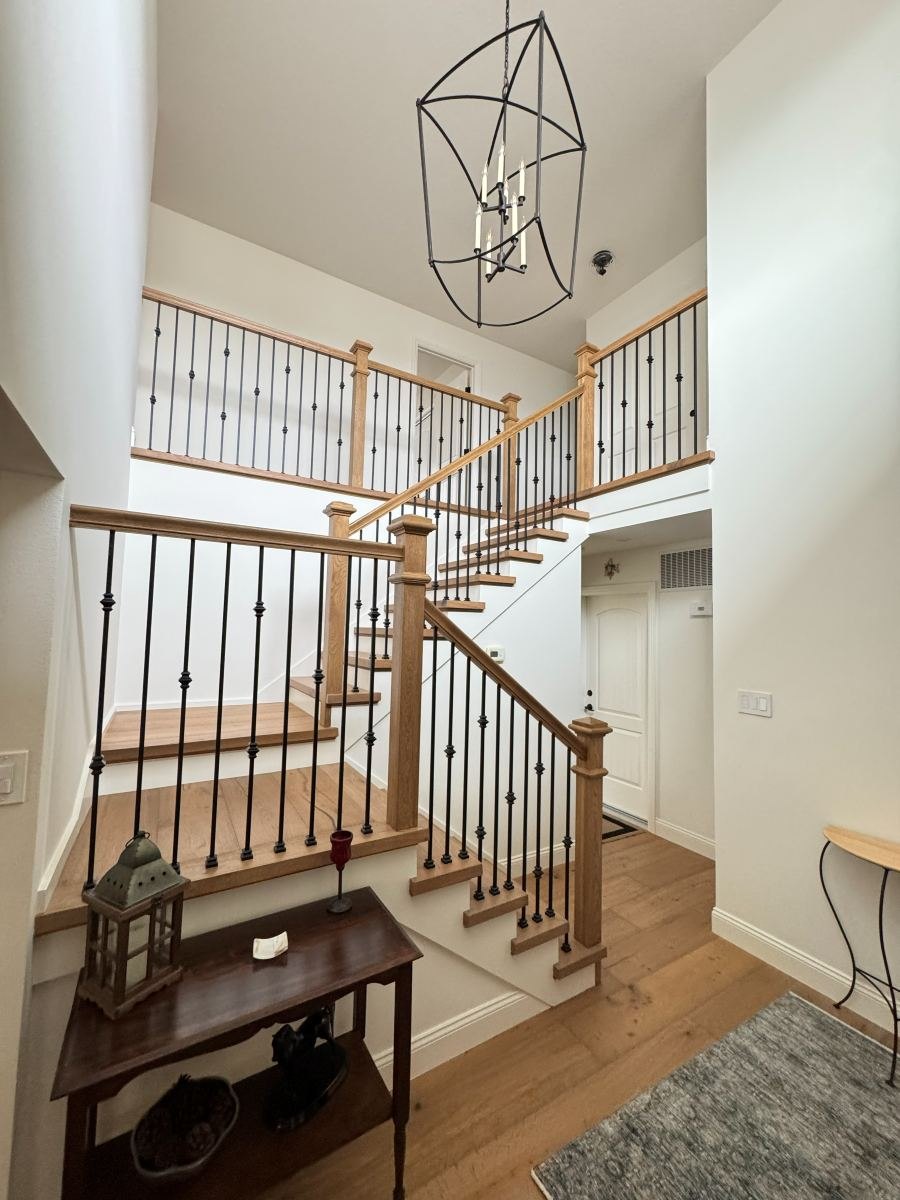 Staircase remodel with iron balusters and oak treads